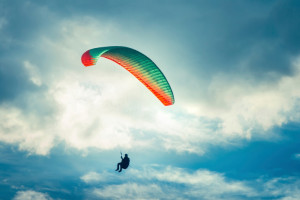 Paragliding extreme Sport with blue Sky and clouds on background